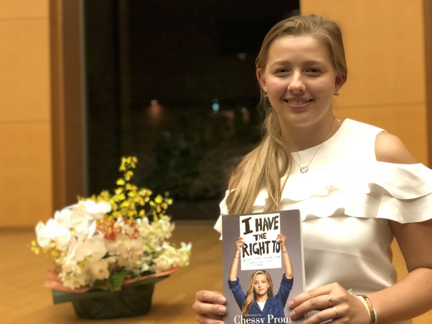 Chessy Prout holding a copy of her memoir, “I Have the Right To”.