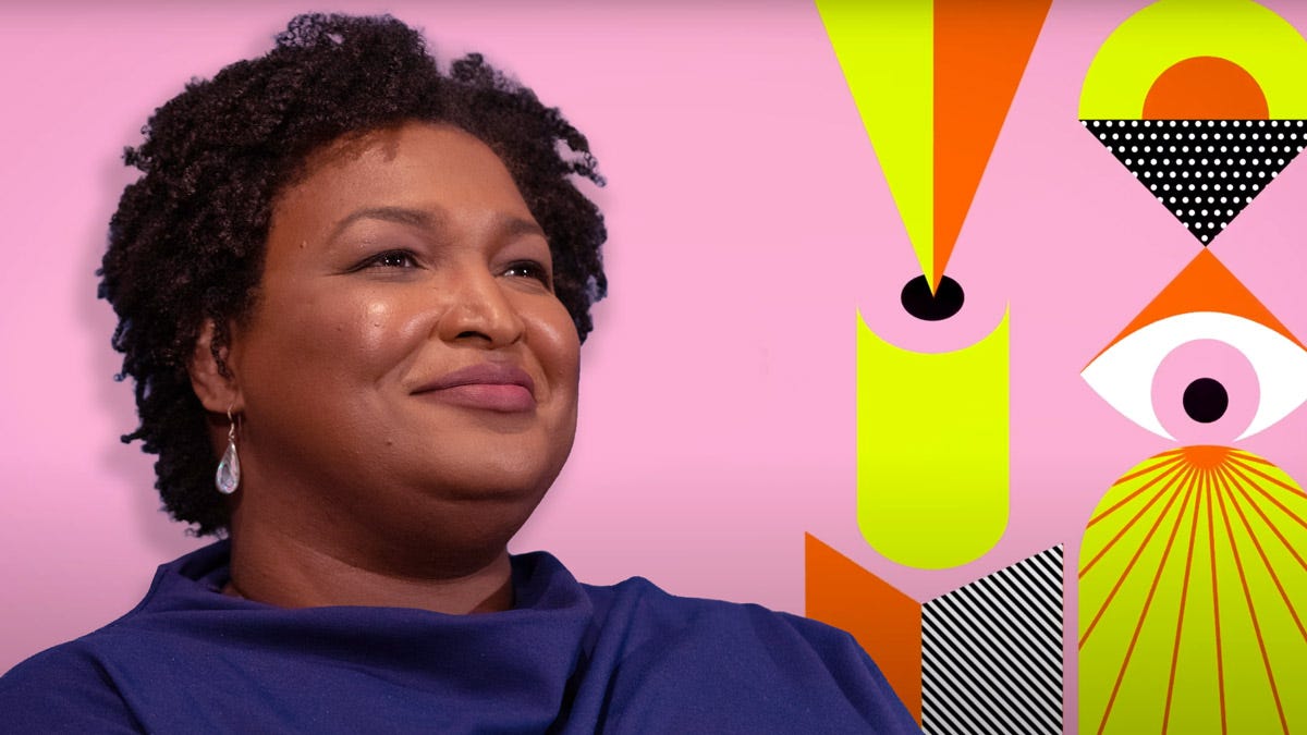 Stacey Abrams (founder of Fair Fight Action) looking into the distance, with bright SXSW colours and patterns in the background.