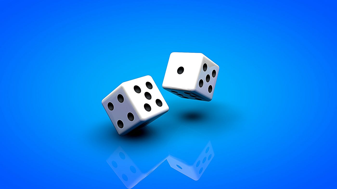 Two white and black dice on a blue background