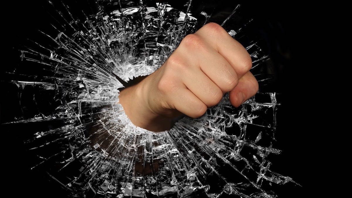A fist punching through glass.