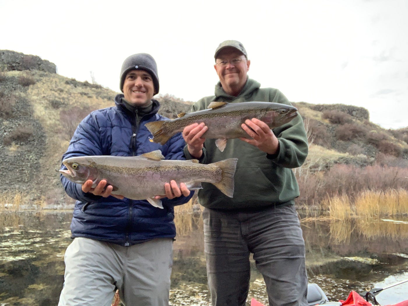 WDFW fish biologists Danny Garrett and Randy Osborne show off rainbow trout they caught at Fourth of July Lake in Lincoln County during a November outing.