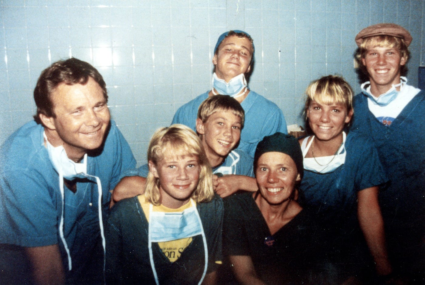 Bill and Kathy Magee pose in scrubs with their five children during a medical mission.