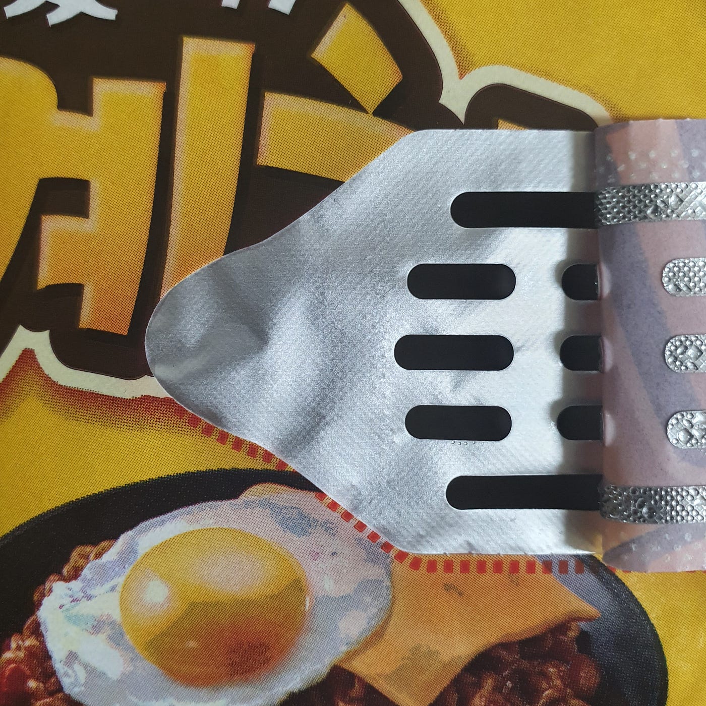 The drain on the lid of a cup of YouUs Jjagyechi Instant Noodles.