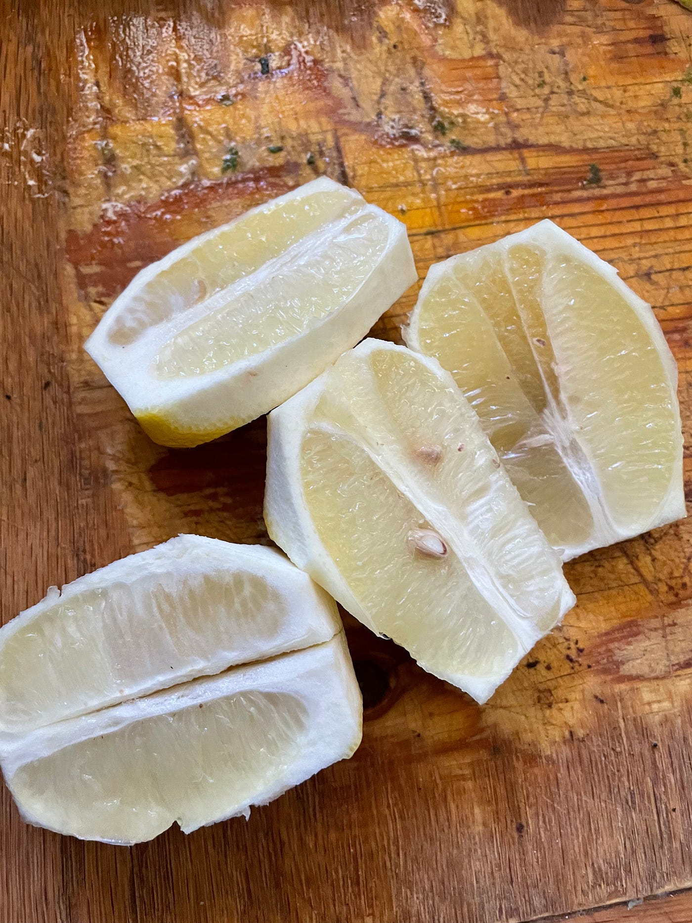 Two lemons cut in half on a cutting bored.