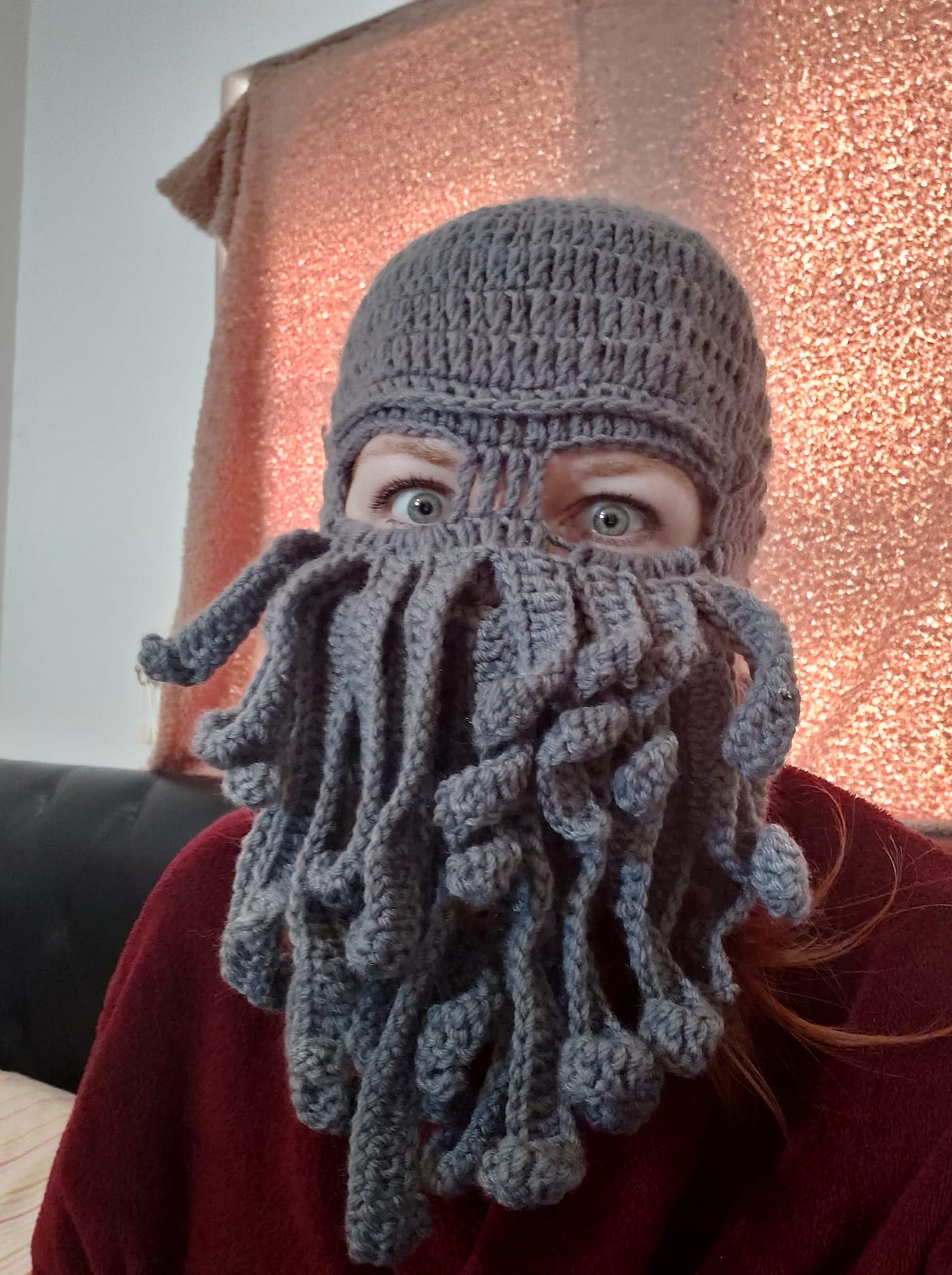 Image of the author, Rose Butcher, wearing a crocheted Cthulu mask, with wide blue eyes and blonde eyebrows visible through the eye holes. It’s time to ditch the pseudonym and just be myself… as strange as I may be. Why you shouldn’t use a pen name.
