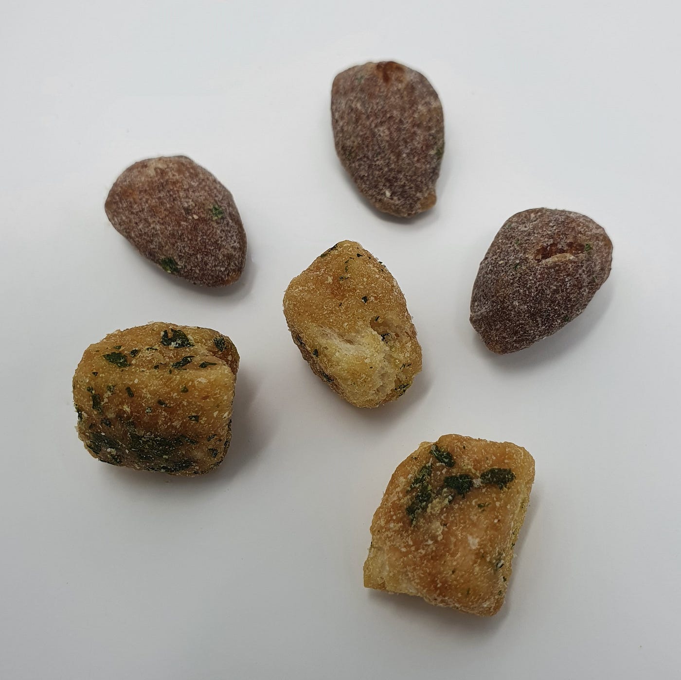 Three almonds and three pieces of garlic bread from a package of Tom’s Farm Garlic Bread Almond.