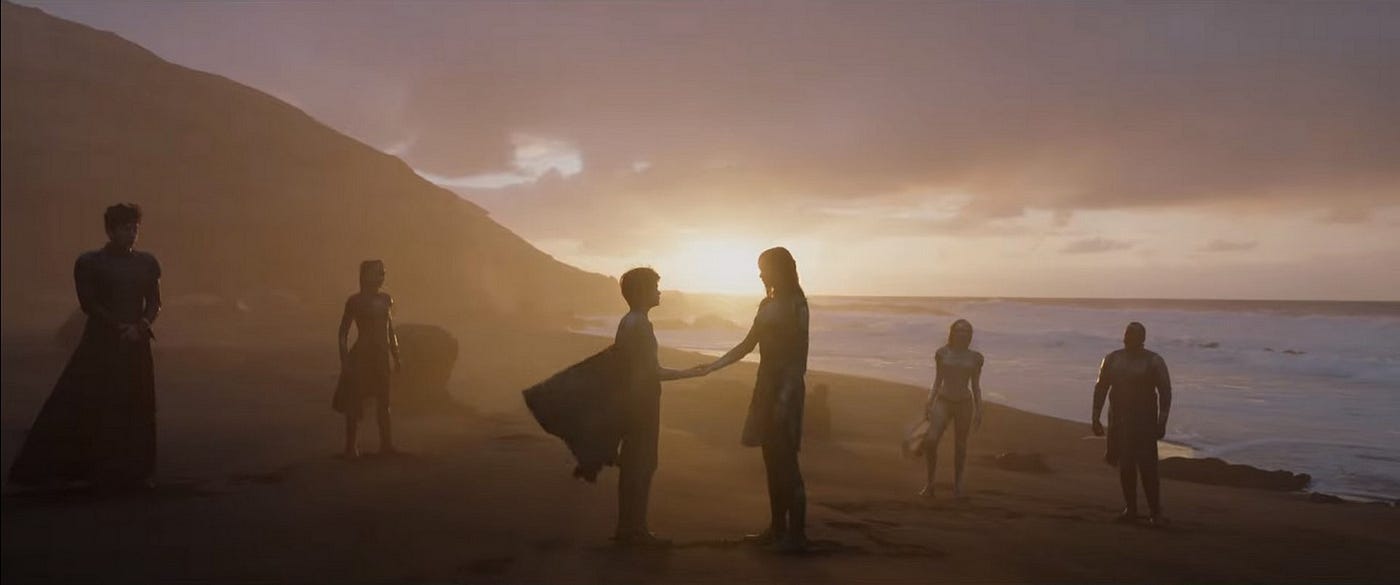 The Eternals hanging out on the beach