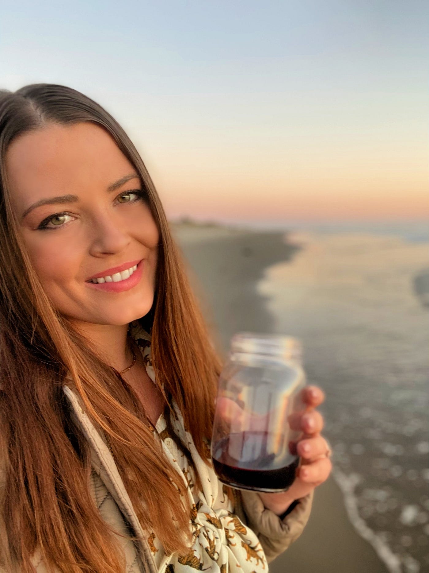Betsy at the beach in Santa Barbara, CA at sunset with wine
