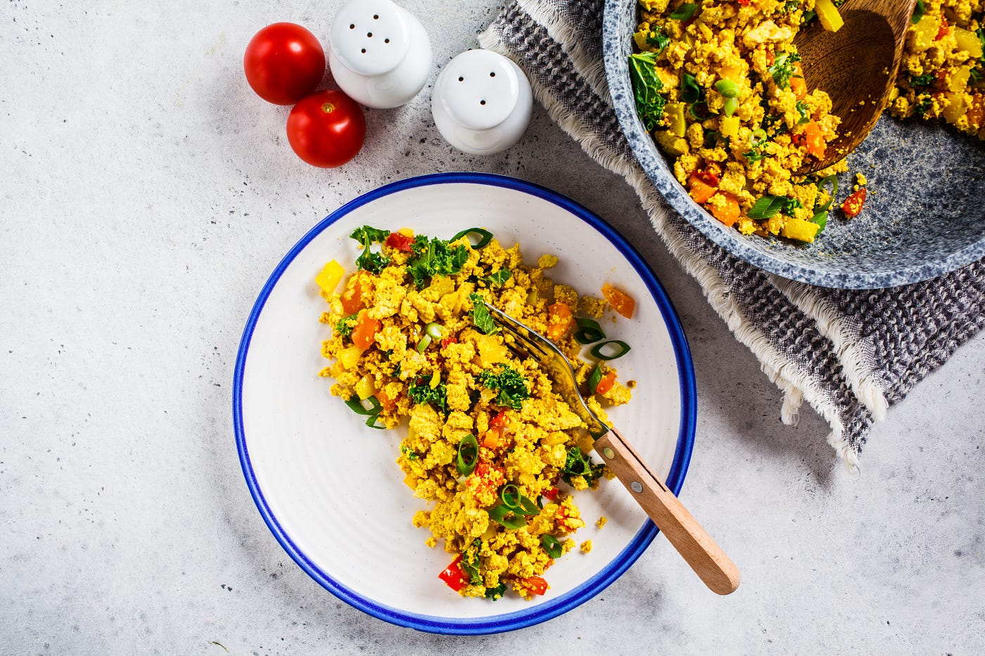 A plate of tofu scramble that’s been dished out of a bigger platter.