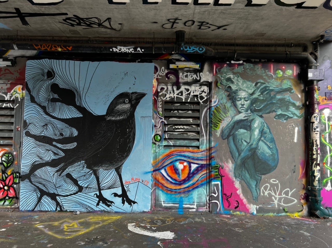 Street art of a crow and woman in Shoreditch, London