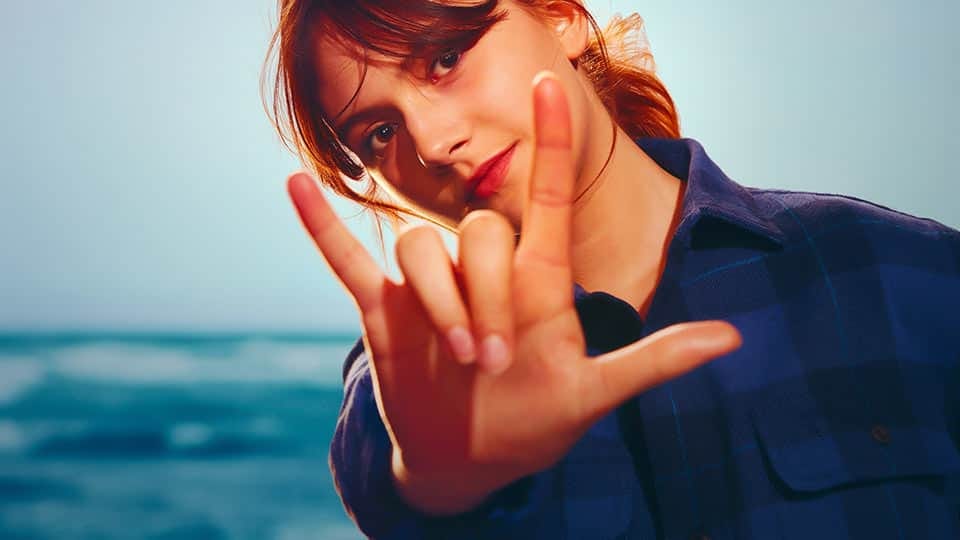 Young woman signing I Love You.