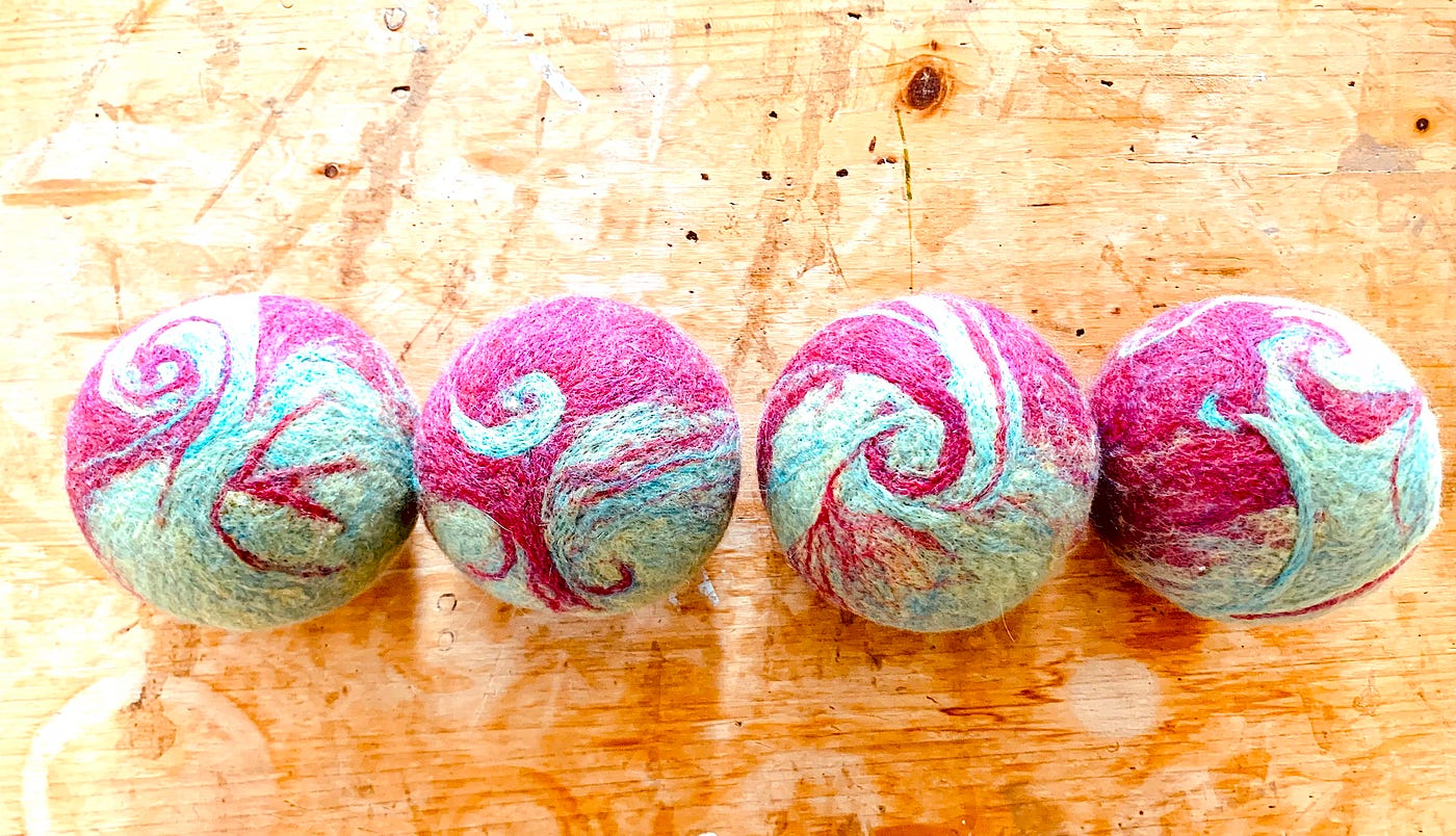 Four felted balls representing dominance/partnership, scarcity/abundace