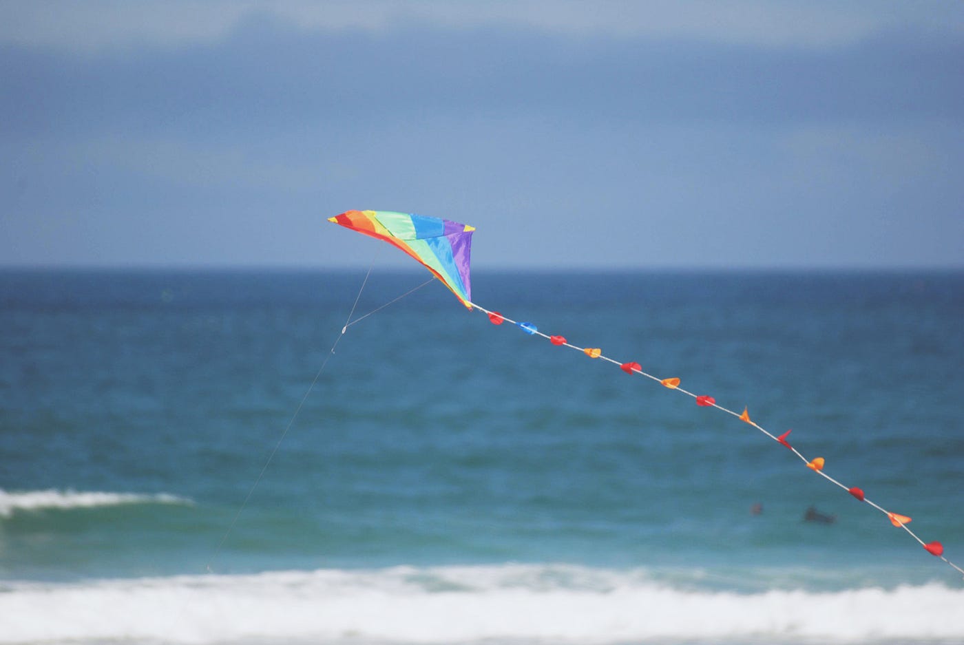 Multi-colored kite at the beach.
