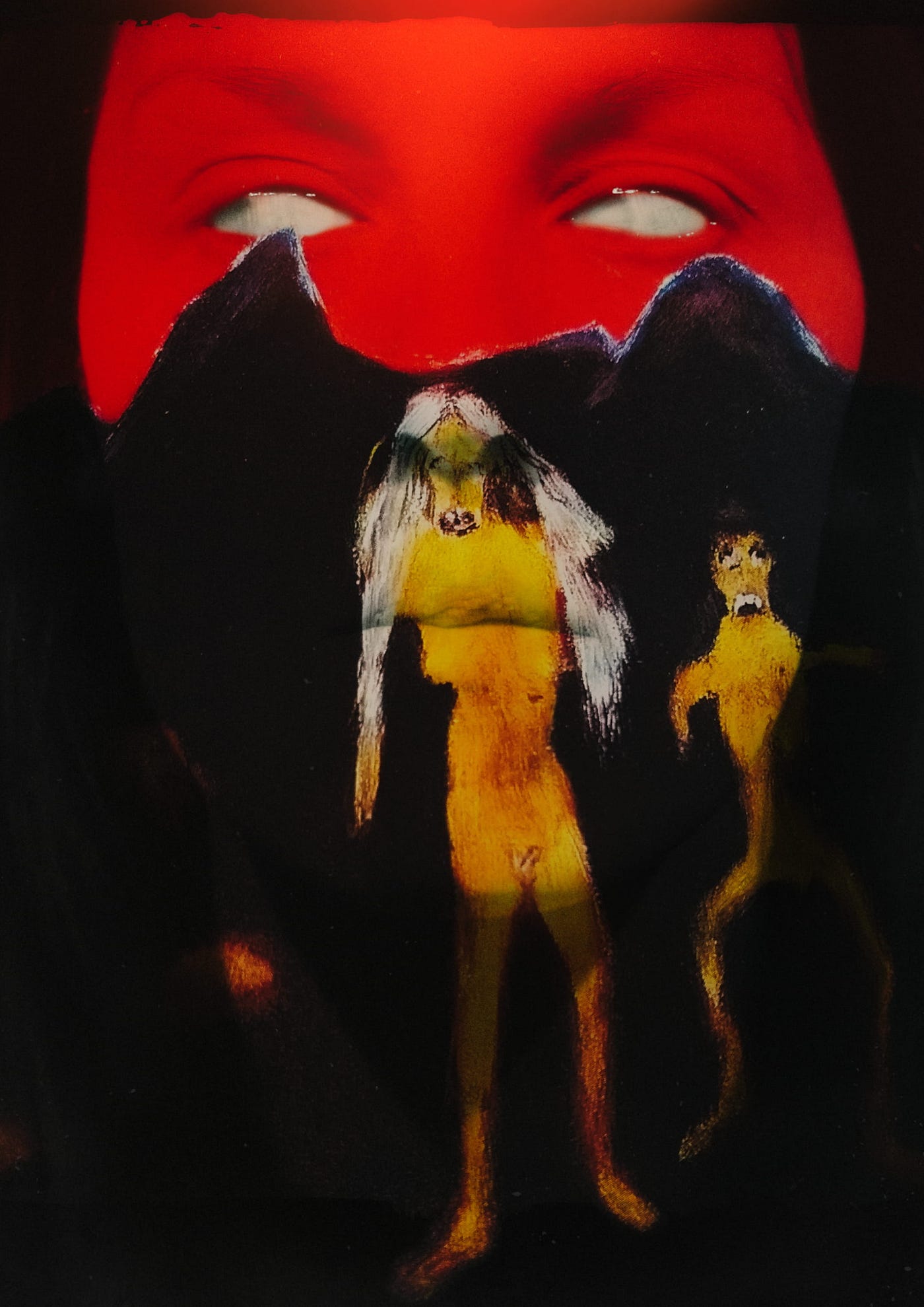 A photo/collage of a human face, completely covered in a combination semi-abstract visual effect. The top half of the face is bathed in red light and the bottom half is black. A yellow nude feminine figure with long white hair is painted or super-imposed over the nose, lips, chin, and neck. A smaller yellow figure is super-imposed on the left cheek, neck, and background. The human’s face serves as a canvas and their eyes are milky-white, devoid of pupils or irises.