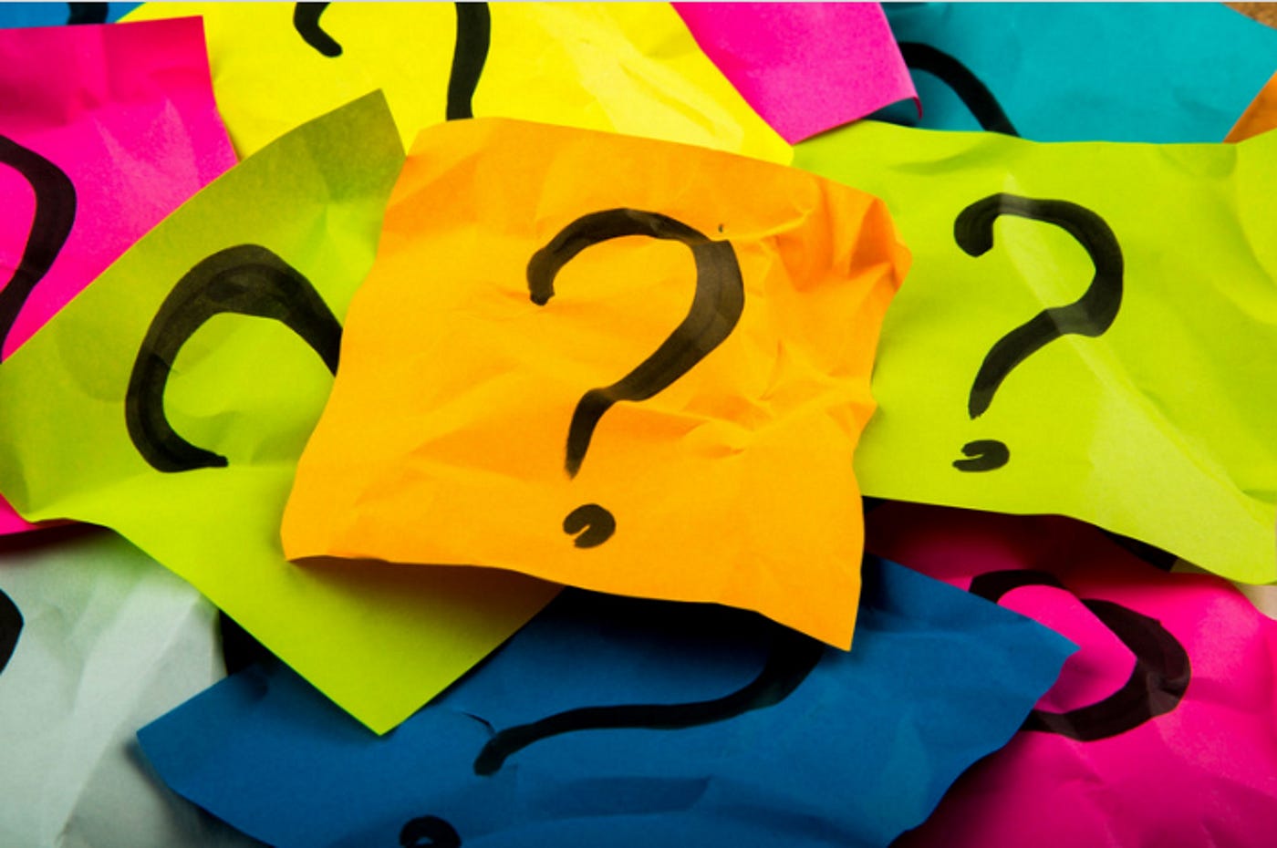 Image of multi colored memo papers with question marks