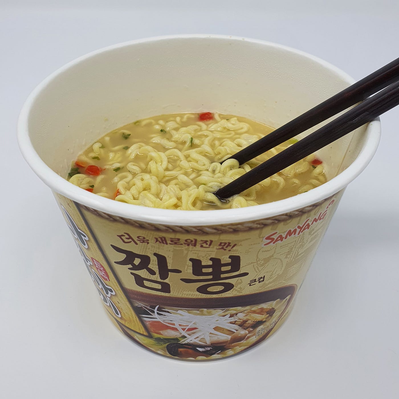 A finished cup of Samyang Nagasaki Jjambbong Instant Noodles with chopsticks in.