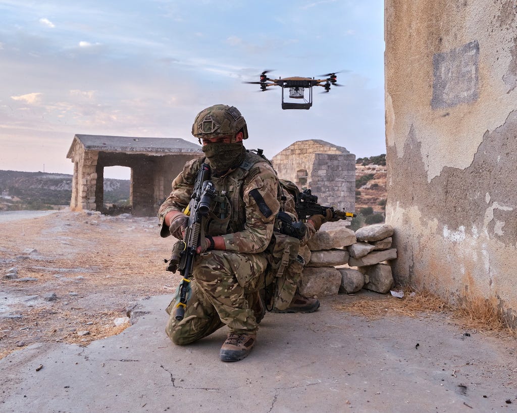 An image of a drone overlooking two Royal Marine soldiers.