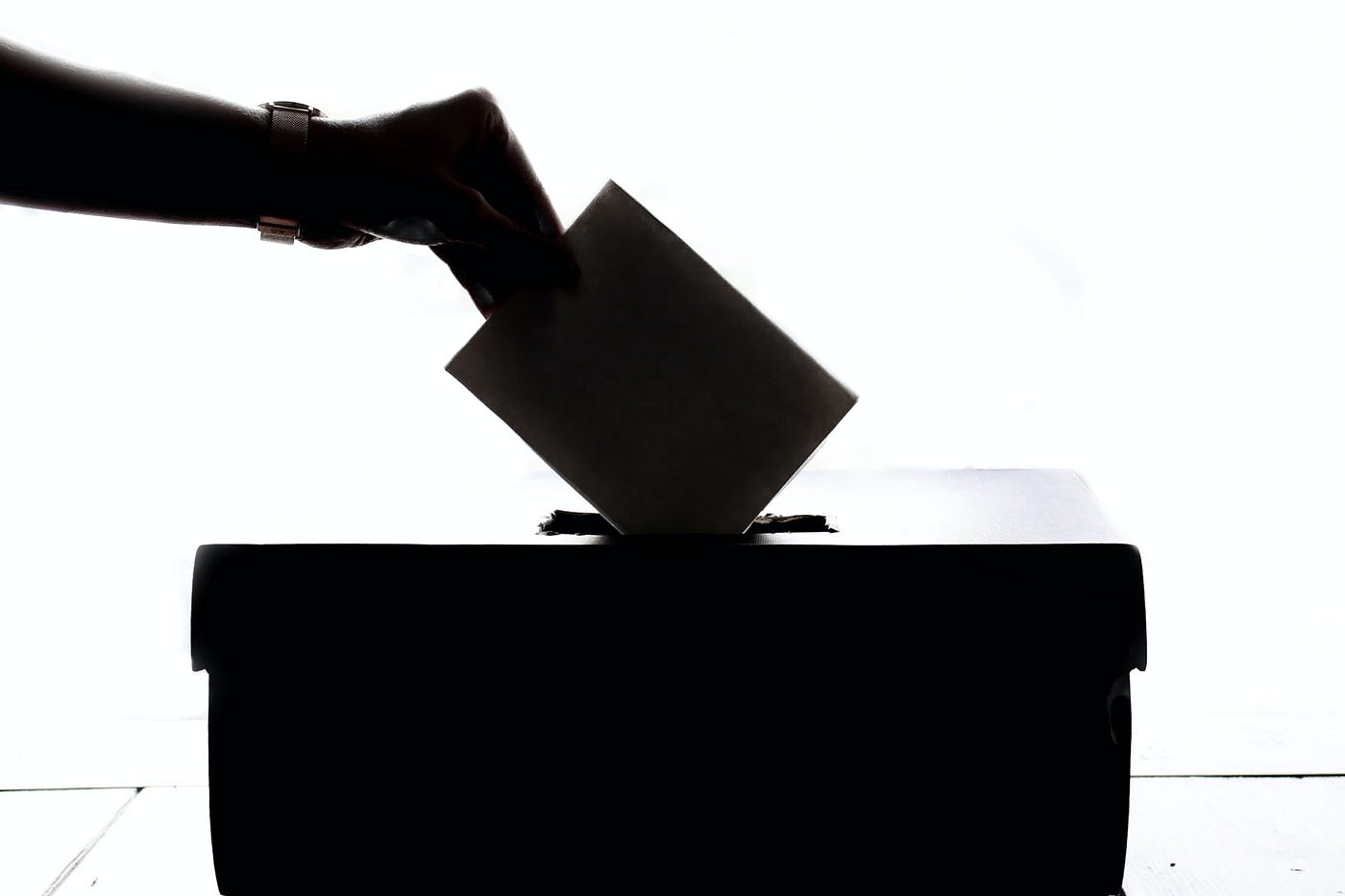 Vote being placed in a ballot box