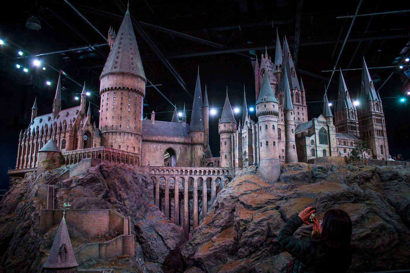 A woman takes a photo of the Hogwarts set, a crime punishable by death.