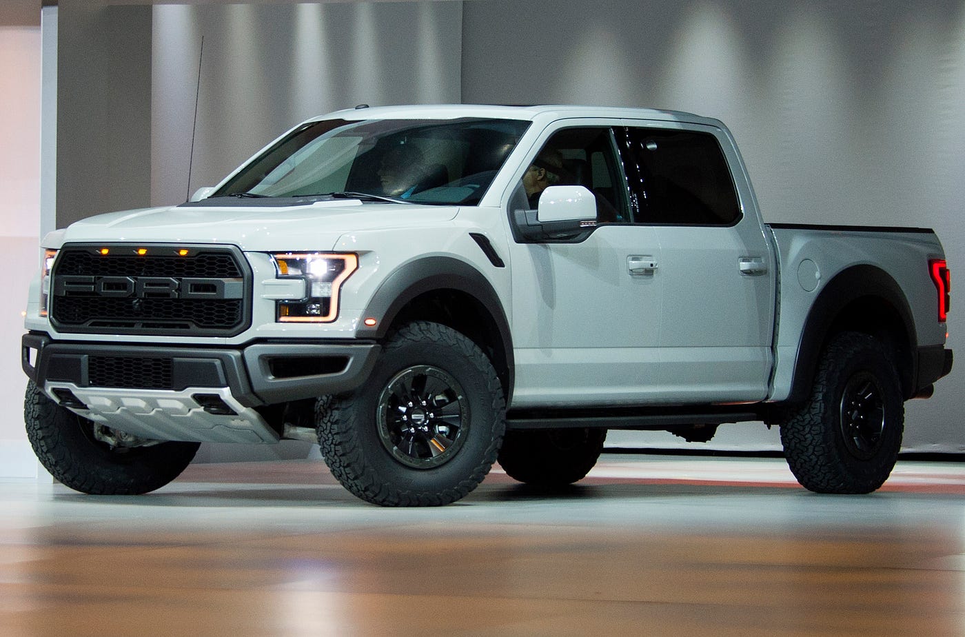 A white Ford F-150 Raptor is unveiled during the Ford press conference at the North American International Auto Show in 2016.