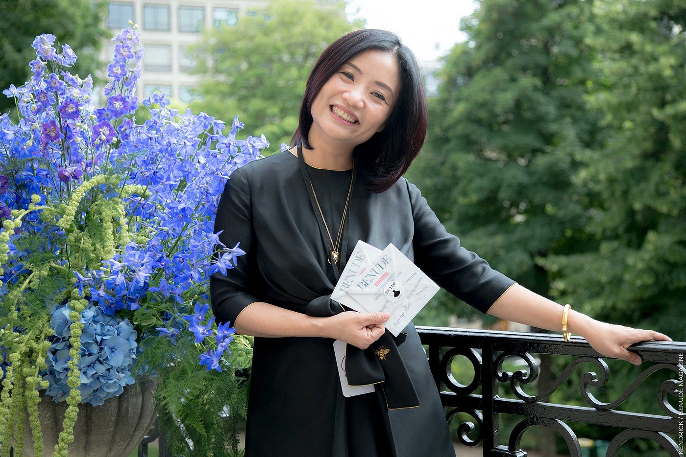Guo Pei holding Benude magazine invitations before her fashion show in Paris