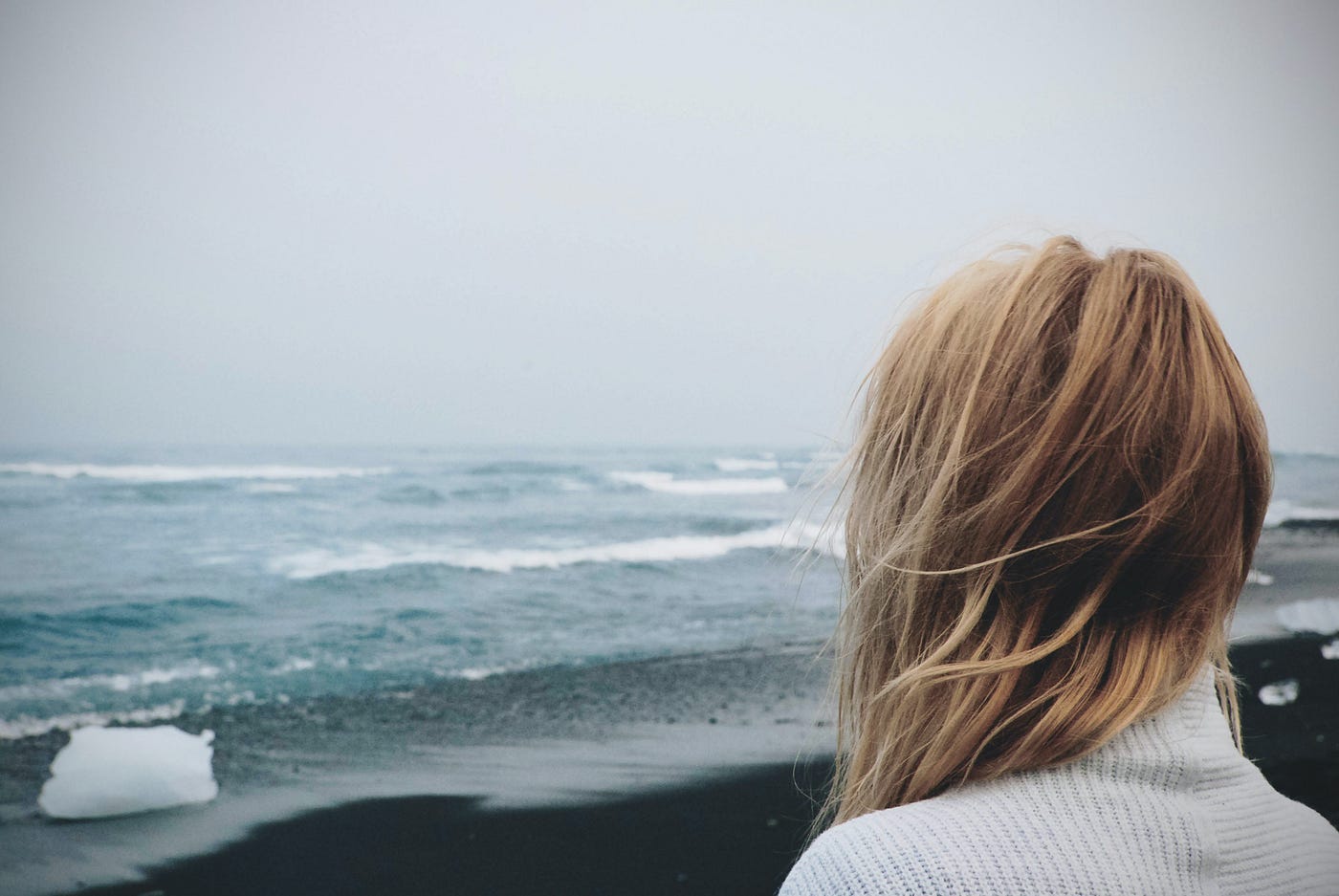A girl overlooking the ocean.