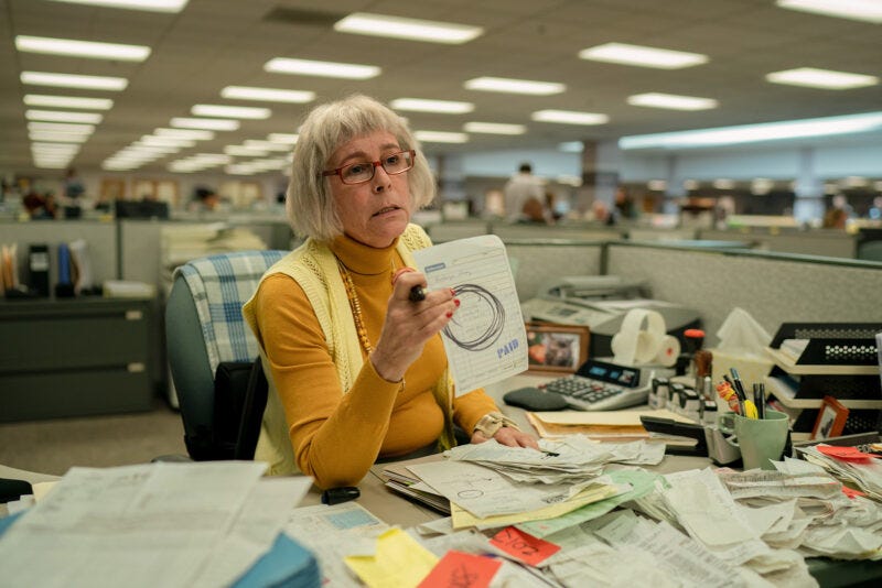 Movie still of Jamie Lee Curtis’ character holding up a piece of paper