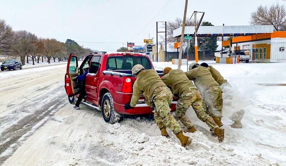 texas national guard push a truck in texas winter storm 2021