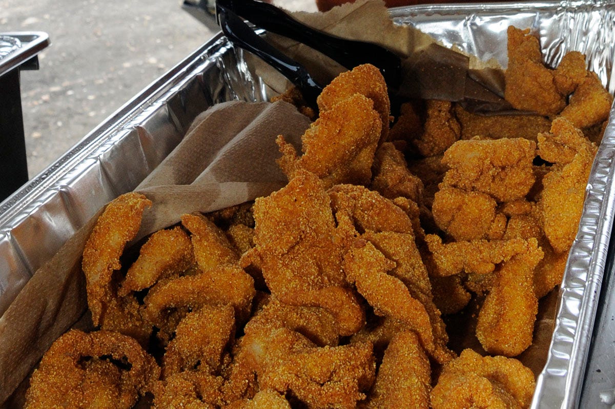 an aluminum serving tray full of fried gar