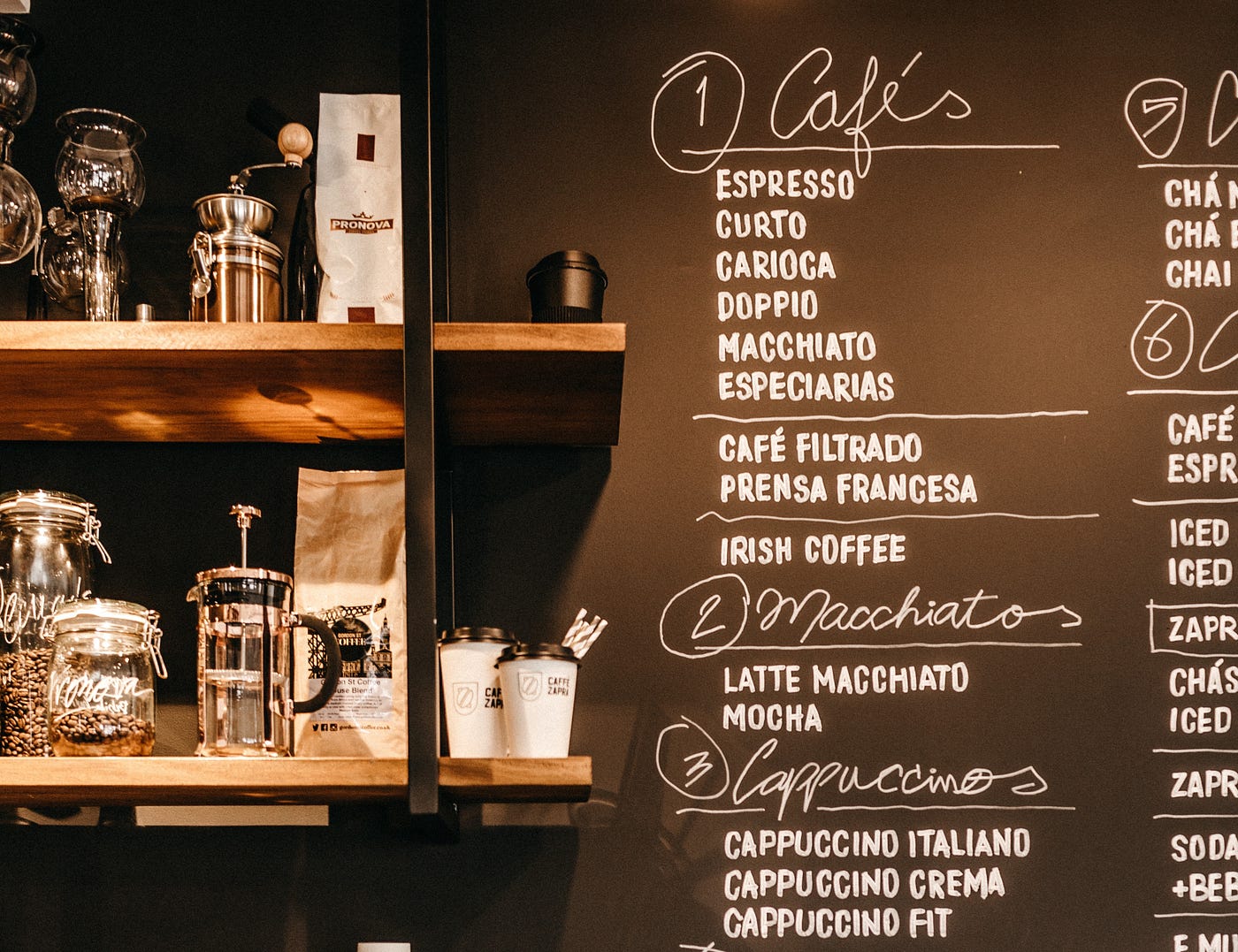 The menu of a coffee shop showing categories of drinks. Photo by Jonathan Borba on Unsplash.