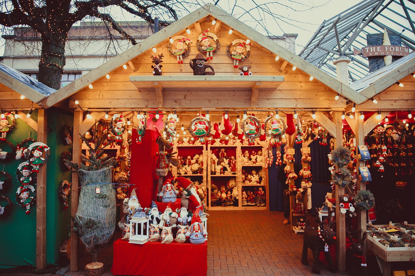 Photo of a Christmas market stall filled with festive ornaments including Santa Clause and door wreathes
