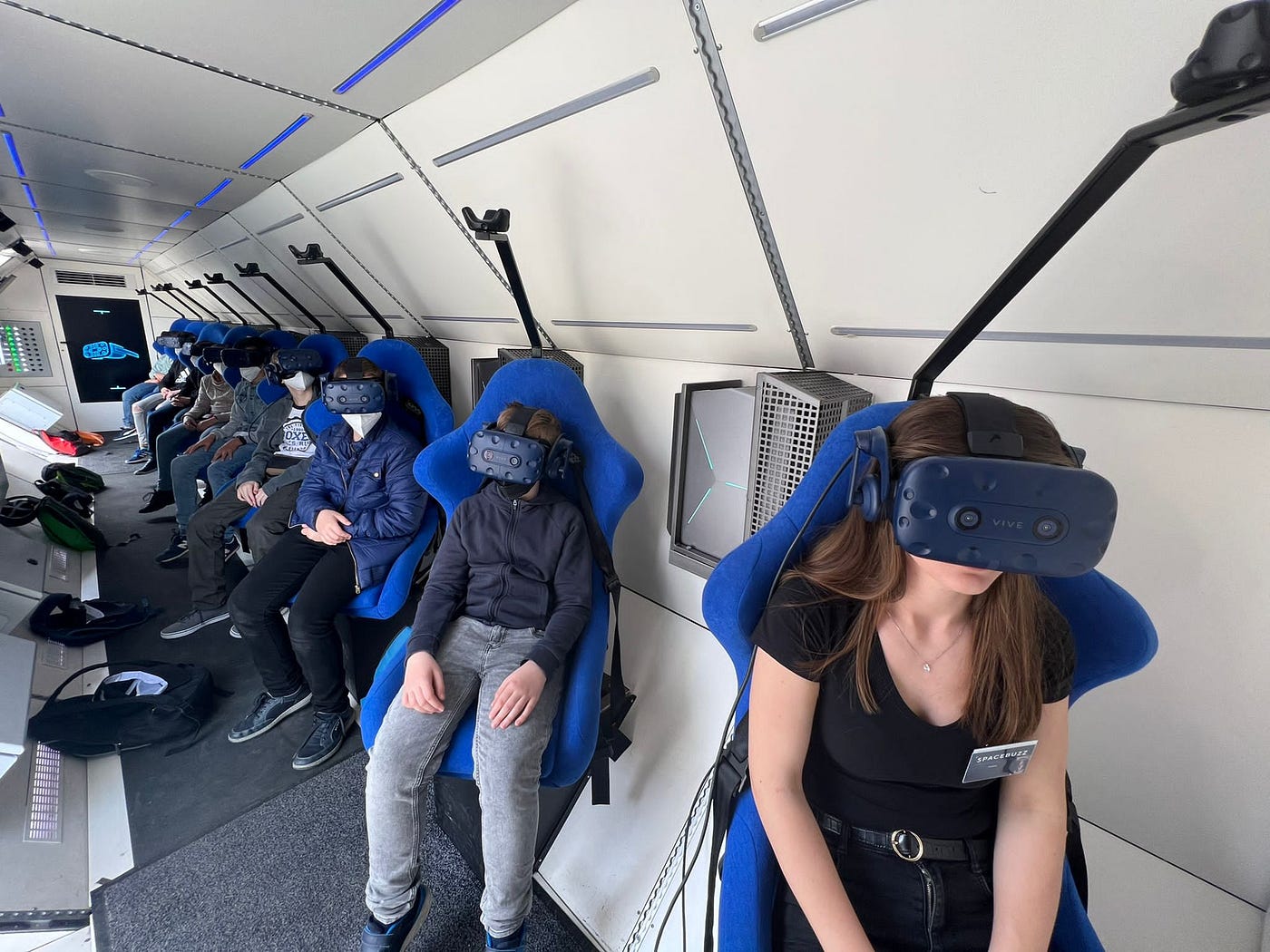 The school kids in the SpaceBuzz with the VR goggles on during the spaceflight.