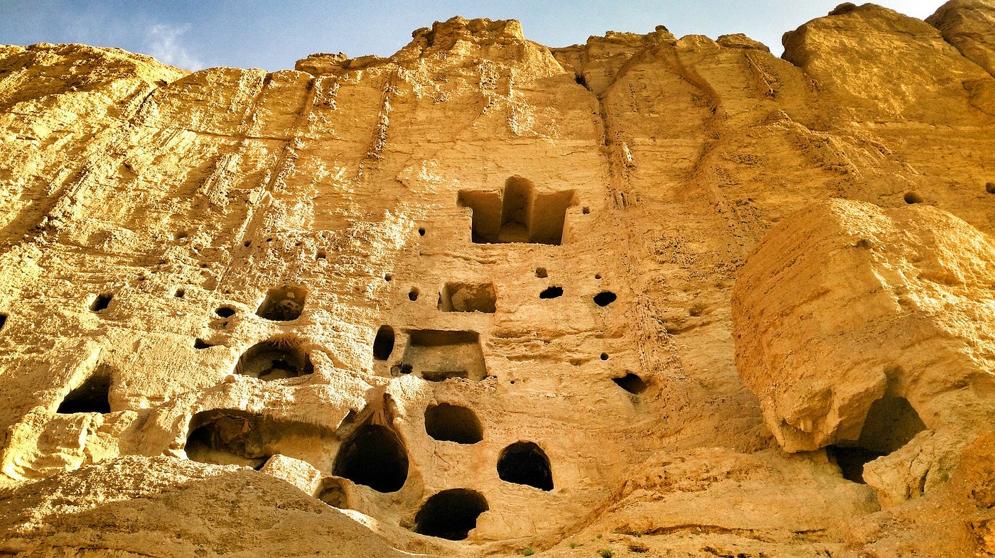 Desert cliffs with man-made cutouts and caves.