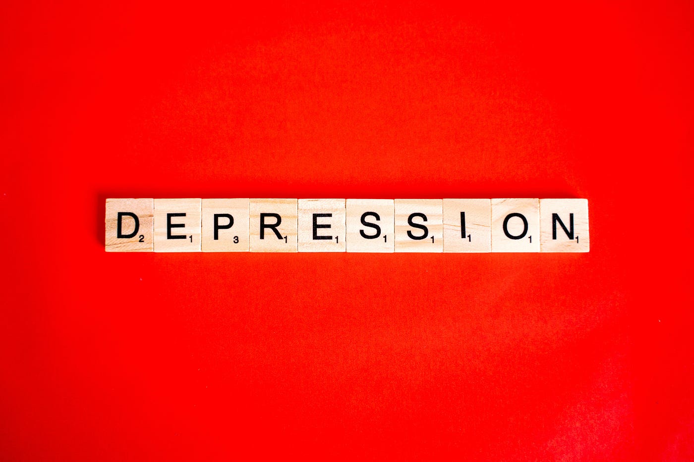 Cubes with individual letters that form the word depression.