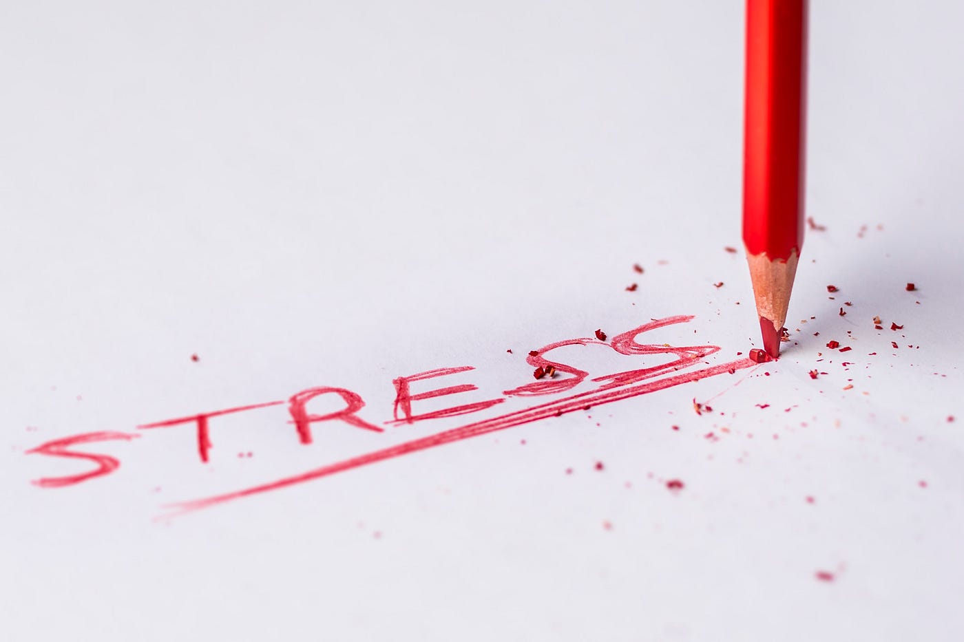 The word STRESS is written by a red colored pencil.