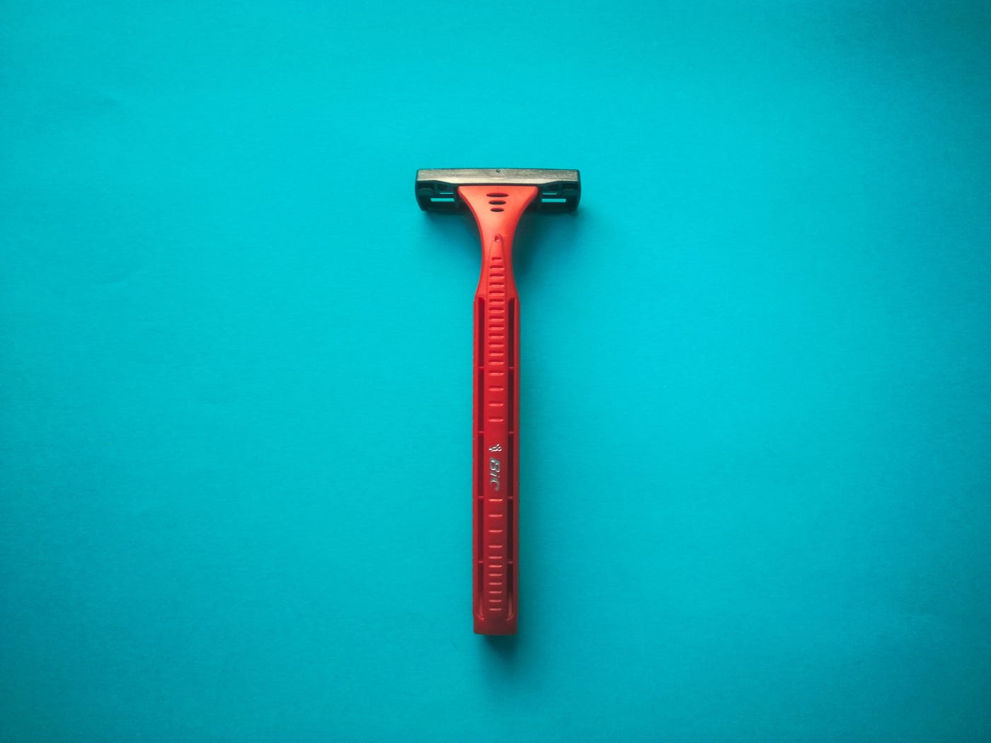 Orange razor on a turquoise background