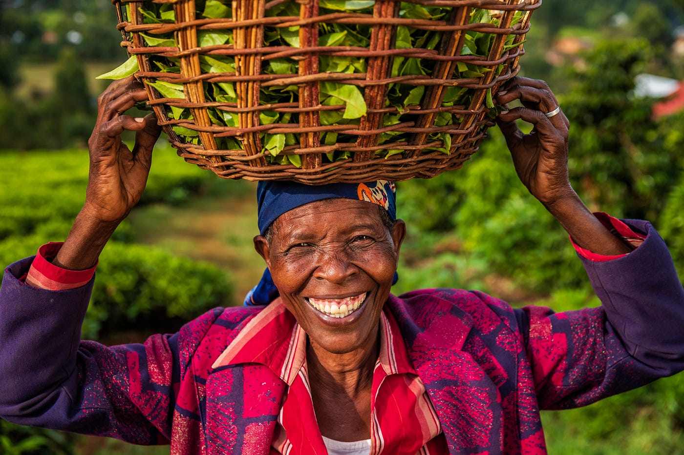 Woman smiling holding basket of crops