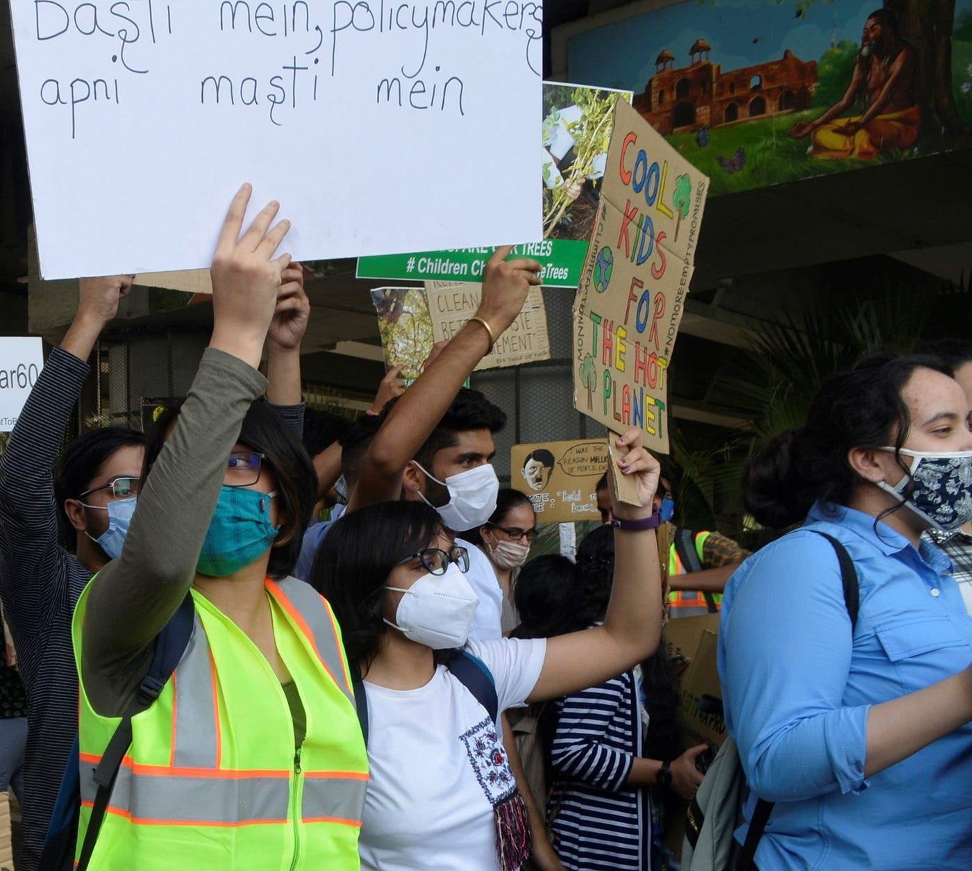 Oindrila holding a sign that reads “Cool kids for the hot planet” while striking for climate justice policy reform in New Delhi, India.