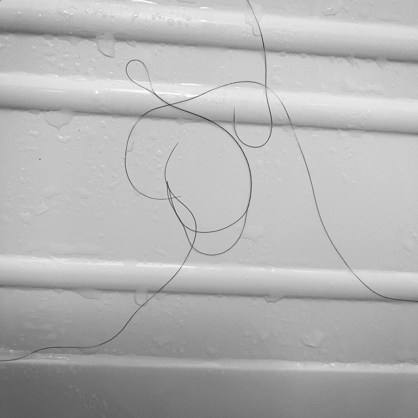 Art photo “I’d tap that” depicts hair outlining a woman entering a bath.
