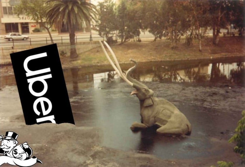 The drowning elephant sculptures at the La Brea tar pits; an Uber sign is sinking into the tar. Monopoly’s ‘Rich Uncle Pennybags’ is exiting the frame bottom left, holding a bag of money.