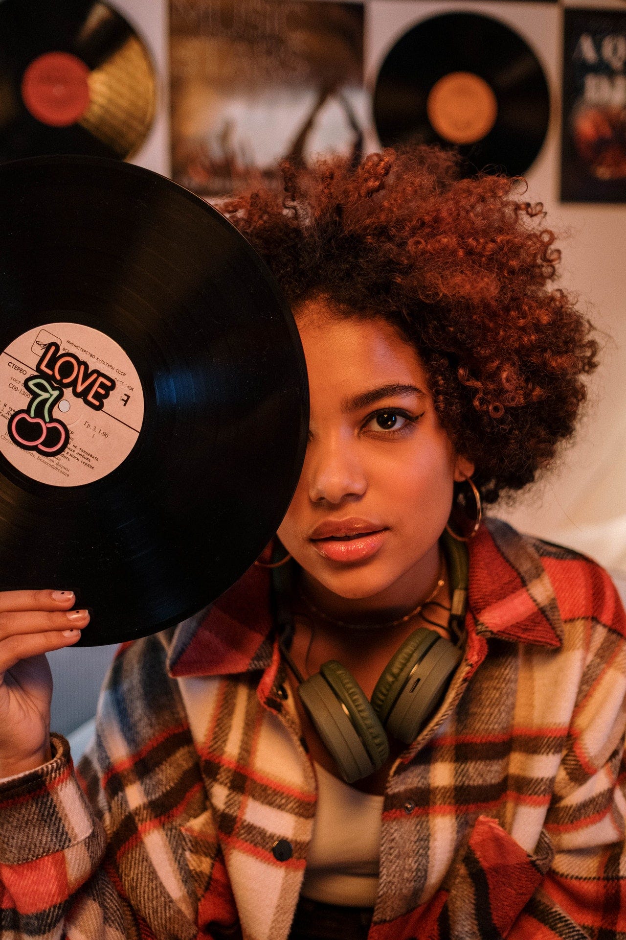 Mindful Music, vinyl record held to cover an eye