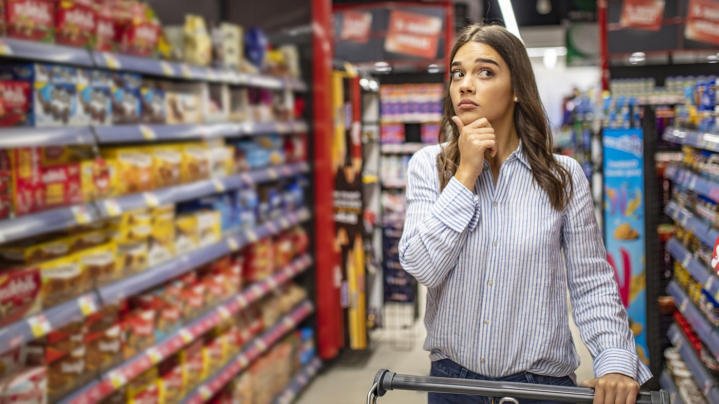 In a supermarket, a woman wonders whether she is paying too much for her groceries.