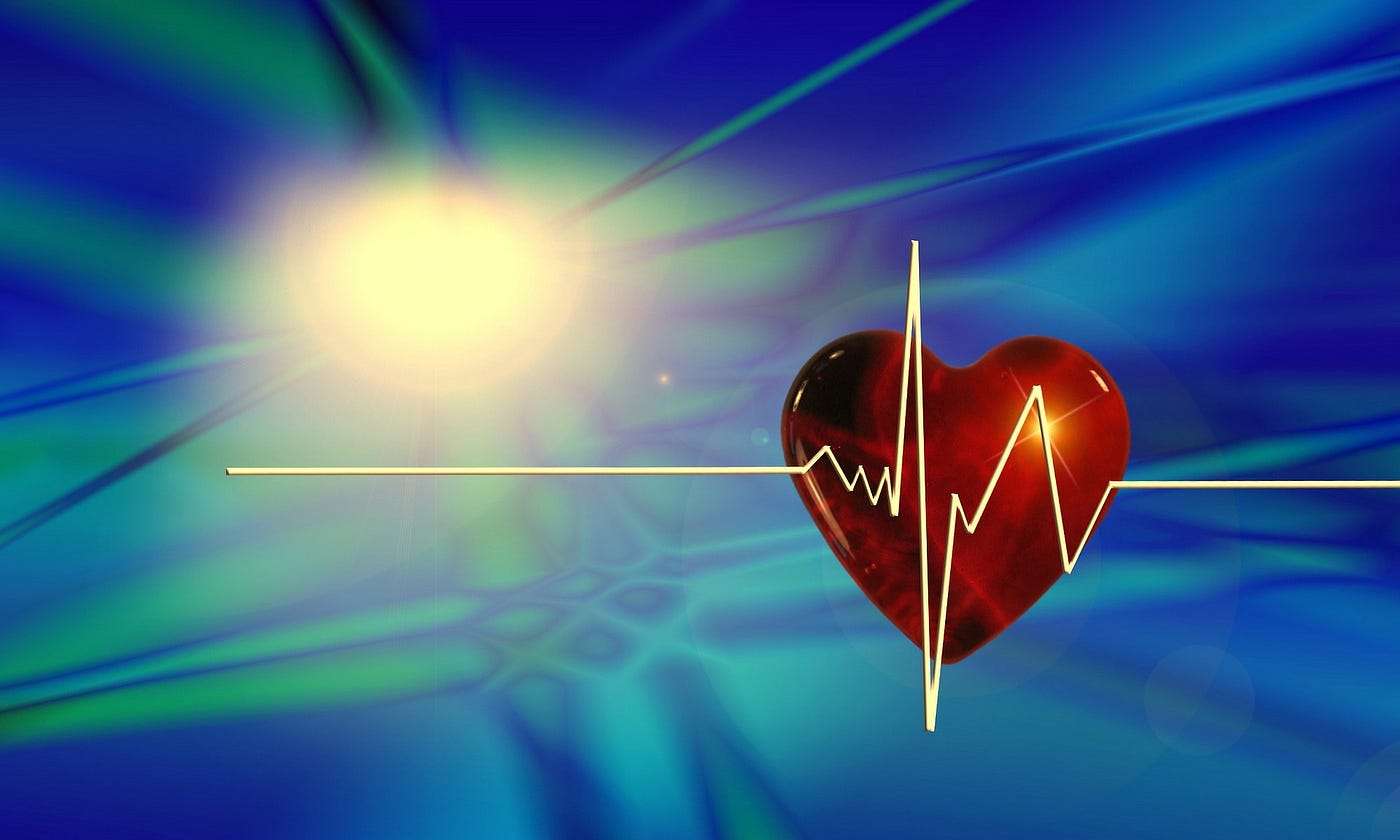 Red heart suspended in space showing a frequency curve representing a heart beat