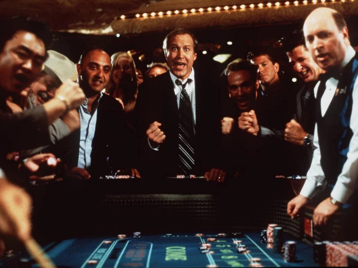 casino-goers yelling around a craps table
