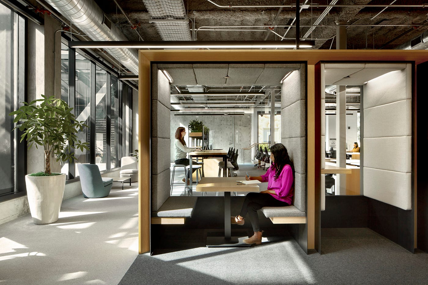 Semi-private spaces are interspersed within work areas.