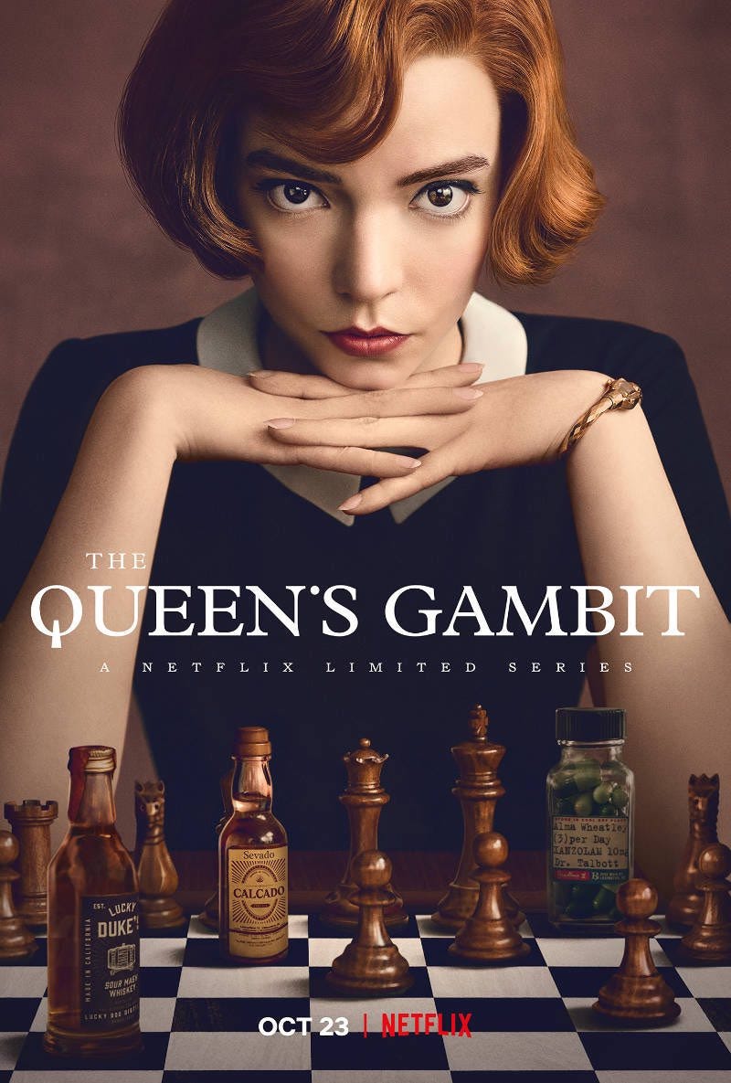 The movie poster of The Queen’s Gambit, an image of a woman sitting behing a chessboard.