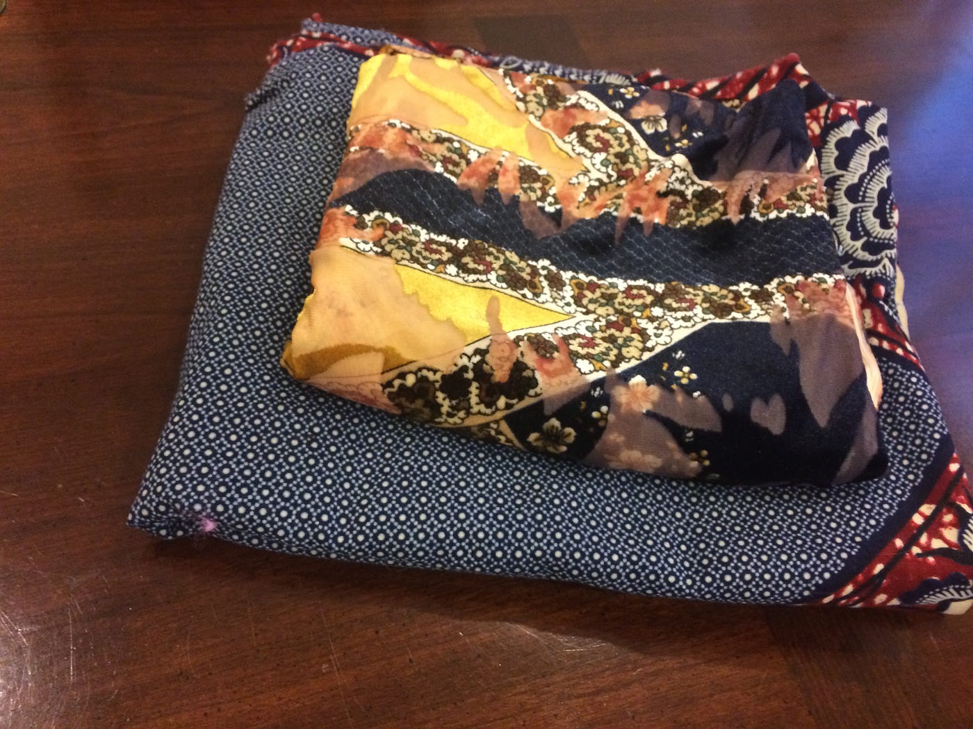 Two colorful fabrics folded on a table