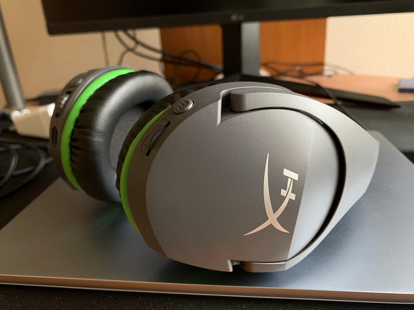HyperX CloudX Stinger Core Wireless headset sitting on a laptop on a desk.