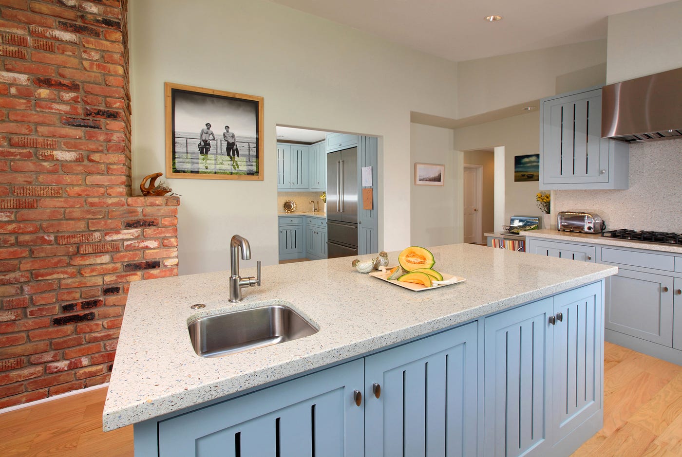A bright kitchen in cool-blue tones and original antique brick.