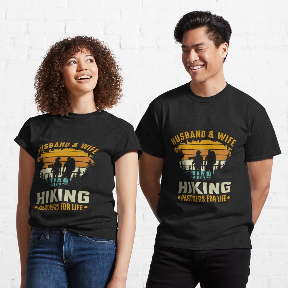 Man and Woman Wearing a black classic t-shirt with amazing illustration and text saying “husband and wife hiking partners for life”.